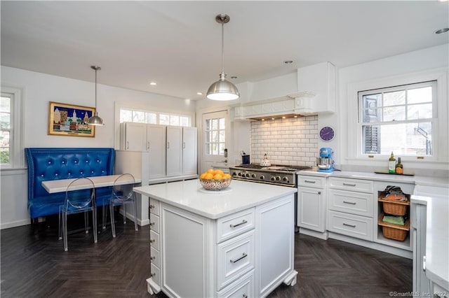 262 Kenyon St, Hartford, CT 06105 - kitchen with light countertops, a center island, white cabinetry, decorative light fixtures, and recessed lighting