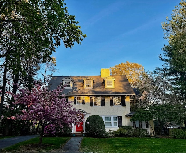 262 Kenyon St, Hartford, CT 06105 - colonial inspired home featuring stucco siding, a front lawn, and a chimney