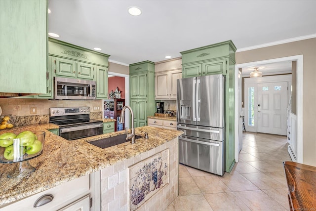 2 White Oak Farm Rd, Newtown, CT 06470 - kitchen featuring appliances with stainless steel finishes, green cabinets, a sink, ornamental molding, and light stone counters