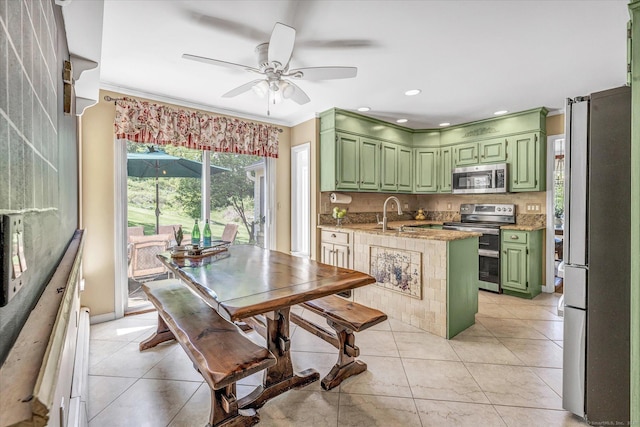2 White Oak Farm Rd, Newtown, CT 06470 - kitchen with green cabinetry, appliances with stainless steel finishes, a ceiling fan, ornamental molding, and decorative backsplash