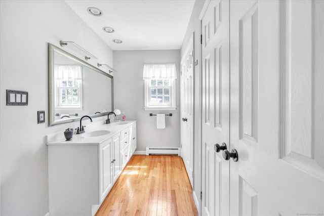 2 White Oak Farm Rd, Newtown, CT 06470 - bathroom with baseboard heating, plenty of natural light, wood-type flooring, and double vanity