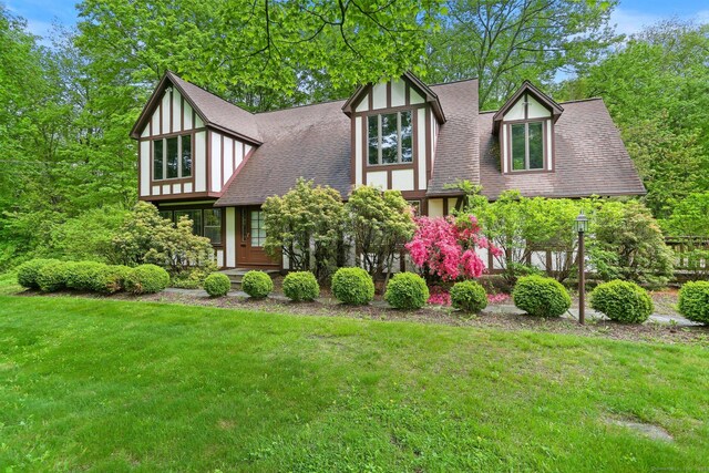 2 Kramer Ln, Weston, CT 06883 - tudor-style house featuring a front yard and a shingled roof