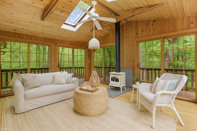 2 Kramer Ln, Weston, CT 06883 - sunroom featuring a skylight, healthy amount of natural light, and a wood stove