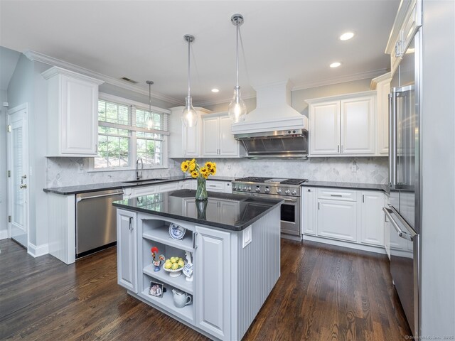kitchen with high quality appliances, custom exhaust hood, dark countertops, white cabinets, and recessed lighting