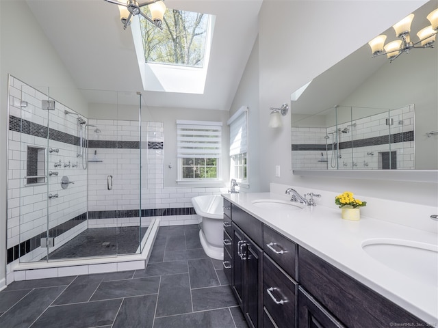 bathroom with a skylight, a stall shower, double vanity, a chandelier, and lofted ceiling