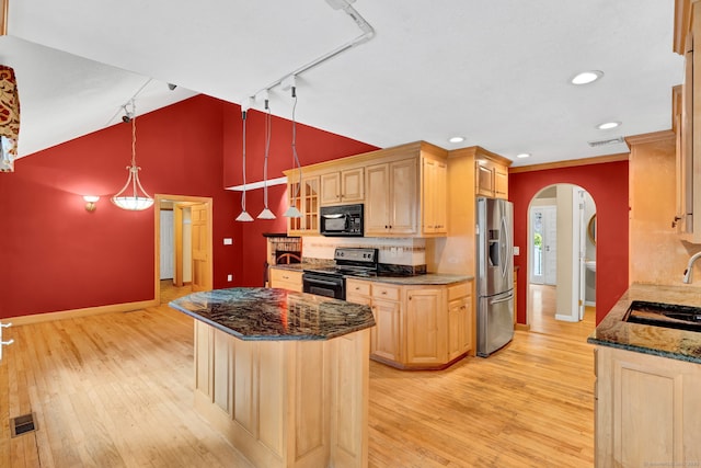 kitchen with black appliances, rail lighting, light brown cabinets, arched walkways, and baseboards