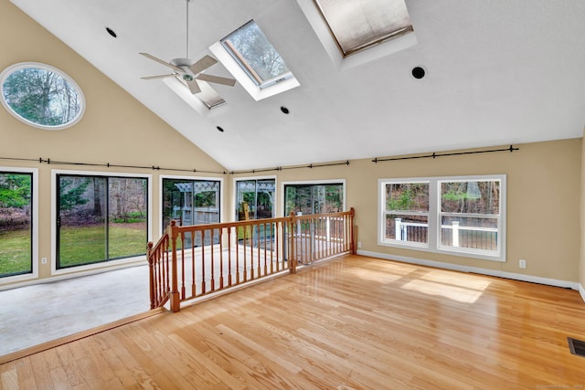 unfurnished sunroom featuring a skylight and vaulted ceiling