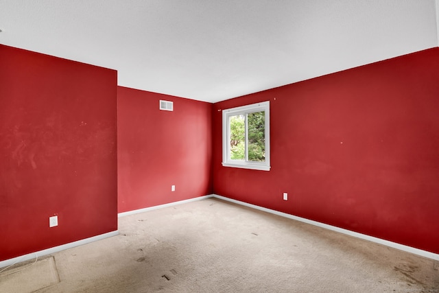 unfurnished room with baseboards and carpet floors