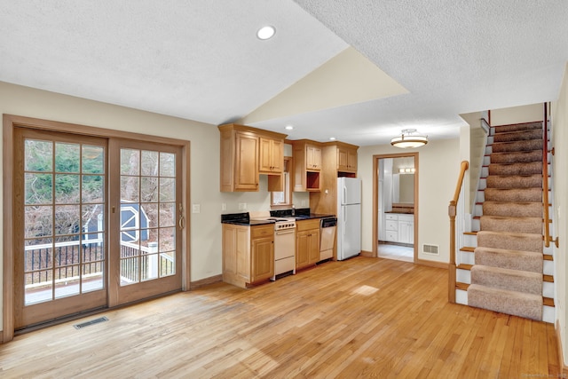 kitchen featuring white appliances, a textured ceiling, light wood-type flooring, baseboards, and recessed lighting