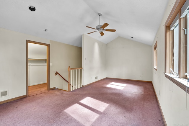 unfurnished room with ceiling fan, carpet floors, vaulted ceiling, and baseboards