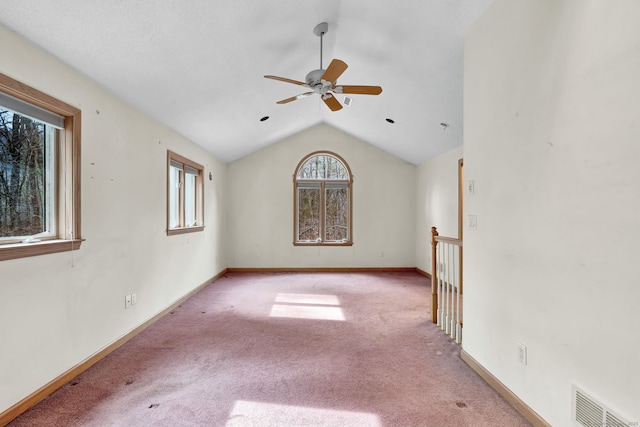 unfurnished living room featuring vaulted ceiling, carpet, ceiling fan, and baseboards