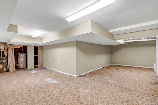 finished below grade area with water heater, carpet, and baseboards