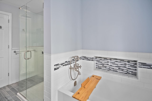 bathroom with a bathing tub and a shower stall
