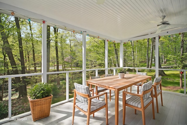 sunroom with outdoor dining space and ceiling fan