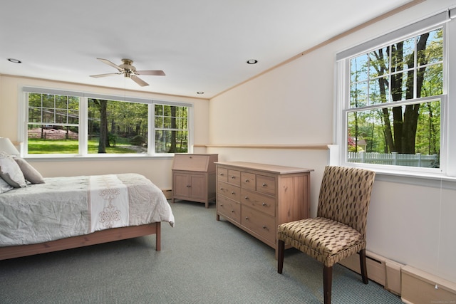 bedroom featuring light carpet, a baseboard heating unit, and recessed lighting