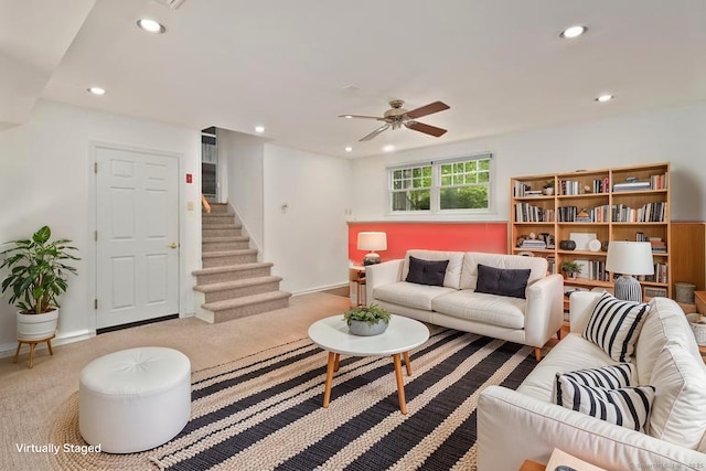 living area with a ceiling fan, stairway, recessed lighting, and baseboards