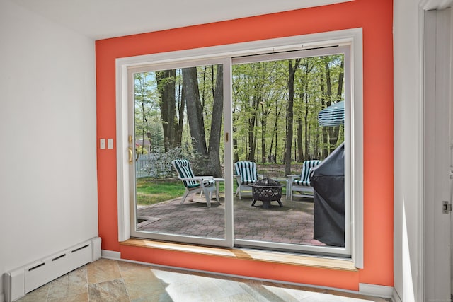 entryway featuring a baseboard heating unit and baseboards
