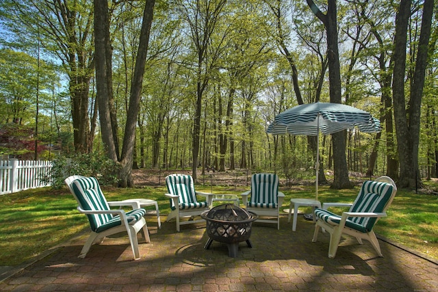view of yard featuring an outdoor fire pit, a patio, and fence
