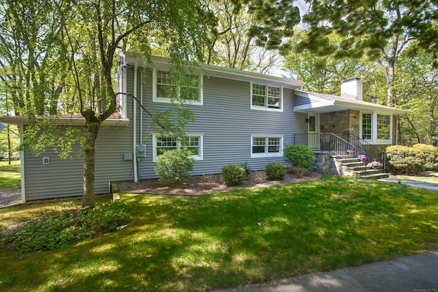 view of front of property with a front lawn and a chimney