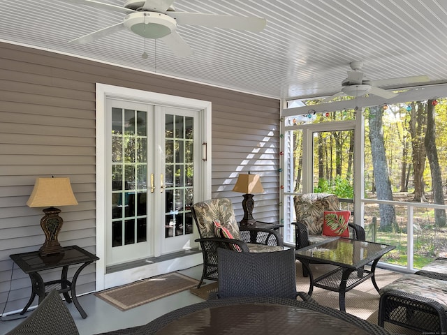 sunroom featuring outdoor dining area, a ceiling fan, and french doors