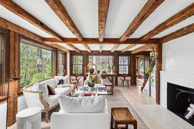 37 Cedar Hls, Weston, CT 06883 - living room with healthy amount of natural light, beam ceiling, light wood-type flooring, and a fireplace with flush hearth