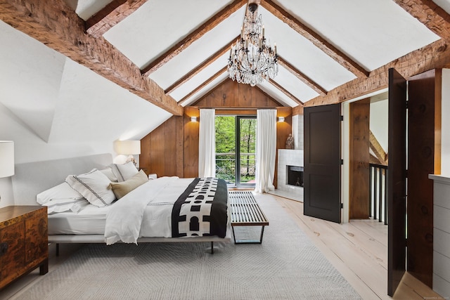 37 Cedar Hls, Weston, CT 06883 - bedroom with light wood-style flooring, wooden walls, a chandelier, and a fireplace