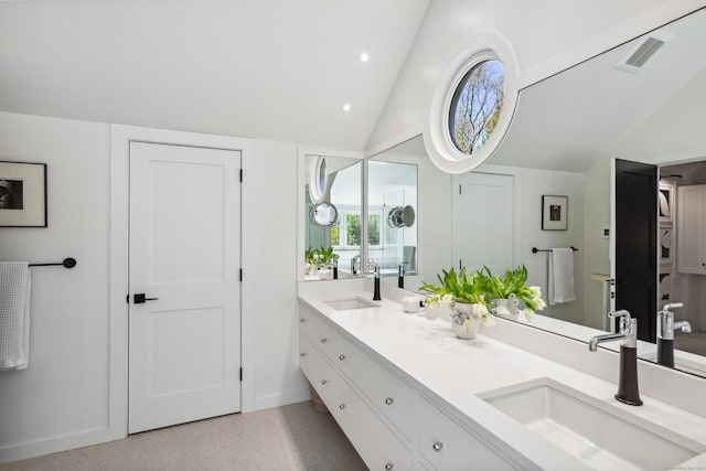 37 Cedar Hls, Weston, CT 06883 - full bathroom with double vanity, vaulted ceiling, speckled floor, baseboards, and recessed lighting