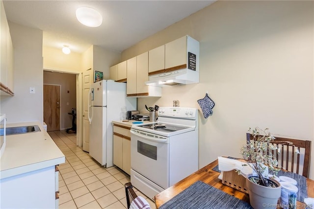 500 Prospect St Apt 1F, New Haven, CT 06511 - kitchen with white appliances, light countertops, light tile patterned flooring, under cabinet range hood, and a sink