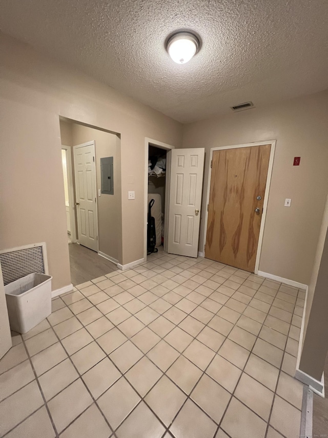 500 Prospect St Apt 1F, New Haven, CT 06511 - spare room with electric panel, a textured ceiling, and baseboards
