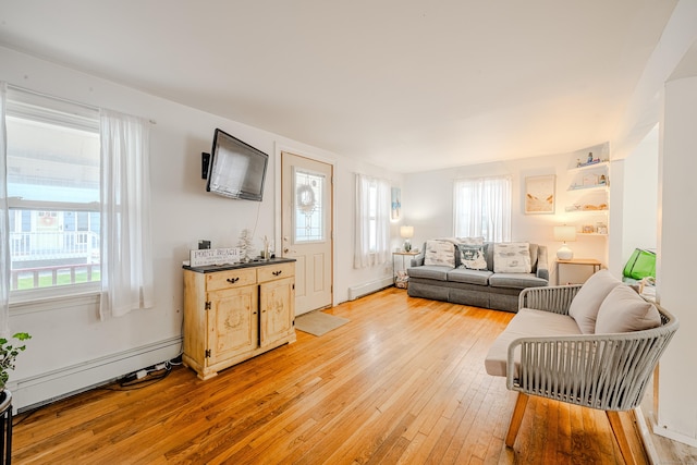 10 Sperry St, Milford, CT 06460 - living room featuring baseboard heating, light wood-style floors, and plenty of natural light