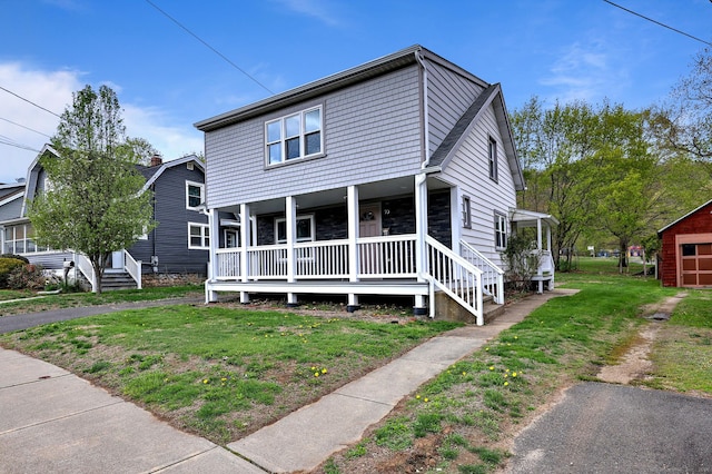traditional-style house with covered porch, a front lawn, and stone siding