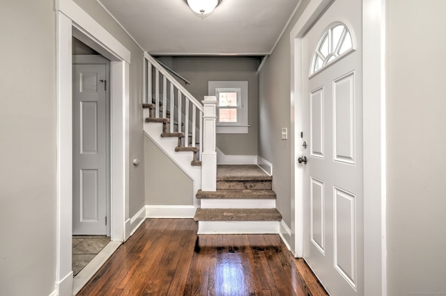 entryway featuring stairway, wood-type flooring, and baseboards