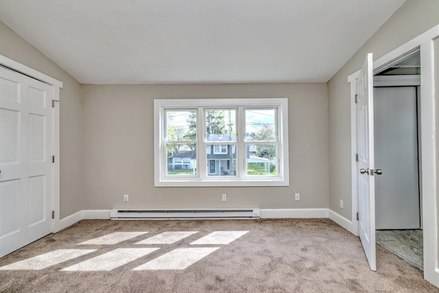 unfurnished bedroom featuring baseboards, a baseboard radiator, and carpet floors