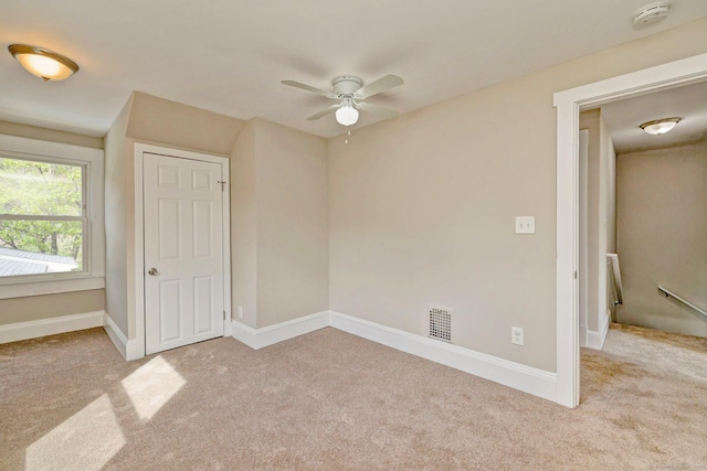 unfurnished bedroom with carpet, visible vents, and baseboards