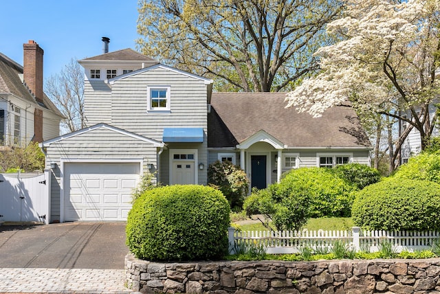 43 Pine Point Rd, Norwalk, CT 06853 - traditional home featuring an attached garage, a gate, fence, roof with shingles, and driveway