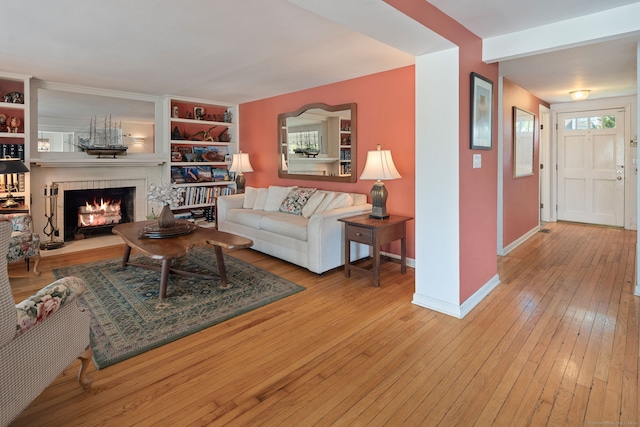 43 Pine Point Rd, Norwalk, CT 06853 - living room with a lit fireplace, baseboards, and hardwood / wood-style floors