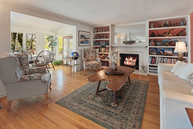 43 Pine Point Rd, Norwalk, CT 06853 - living room featuring a fireplace with flush hearth and wood finished floors