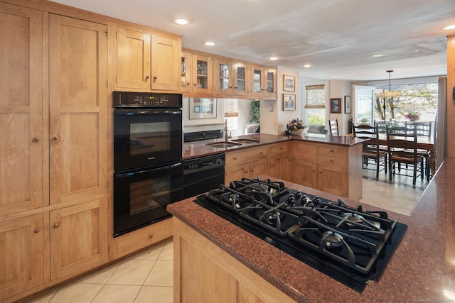 43 Pine Point Rd, Norwalk, CT 06853 - kitchen with a sink, a peninsula, black appliances, and light tile patterned floors