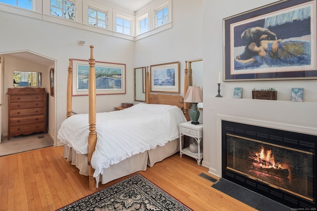 43 Pine Point Rd, Norwalk, CT 06853 - bedroom with multiple windows, light wood finished floors, and a fireplace with flush hearth