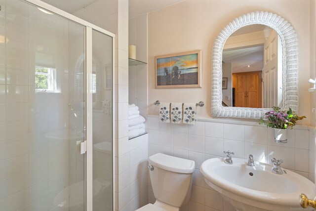 43 Pine Point Rd, Norwalk, CT 06853 - full bathroom featuring a stall shower, tile walls, toilet, and a sink