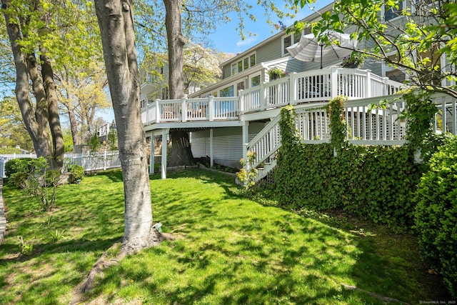 43 Pine Point Rd, Norwalk, CT 06853 - back of property featuring a lawn, stairs, a wooden deck, and fence