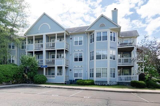 75 Redwood Dr Unit 609, East Haven, CT 06513 - view of property with cooling unit and uncovered parking