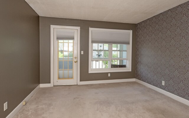 75 Redwood Dr Unit 609, East Haven, CT 06513 - entryway with carpet flooring, wallpapered walls, baseboards, and a textured ceiling