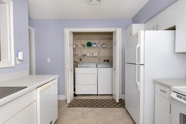 75 Redwood Dr Unit 609, East Haven, CT 06513 - kitchen featuring white appliances, independent washer and dryer, light countertops, and white cabinetry