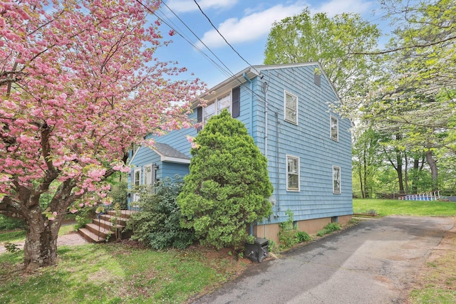 view of property exterior featuring a lawn