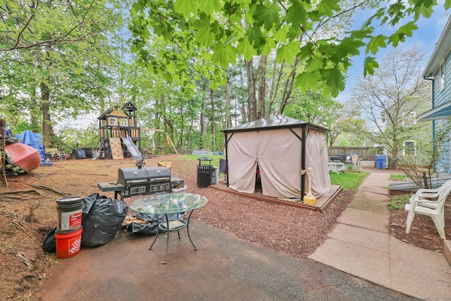 view of patio / terrace featuring a playground and a fenced backyard