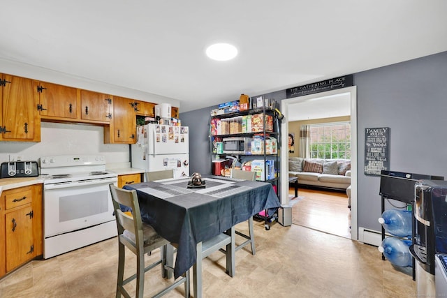 kitchen featuring brown cabinetry, baseboard heating, white appliances, and light countertops