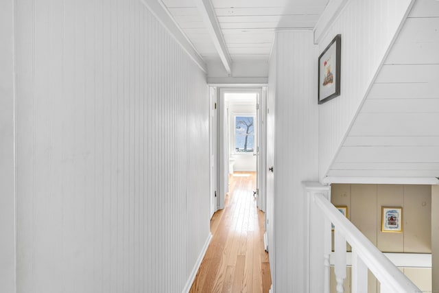 hallway with light wood-type flooring and stairway