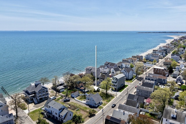 aerial view of residential area featuring a large body of water