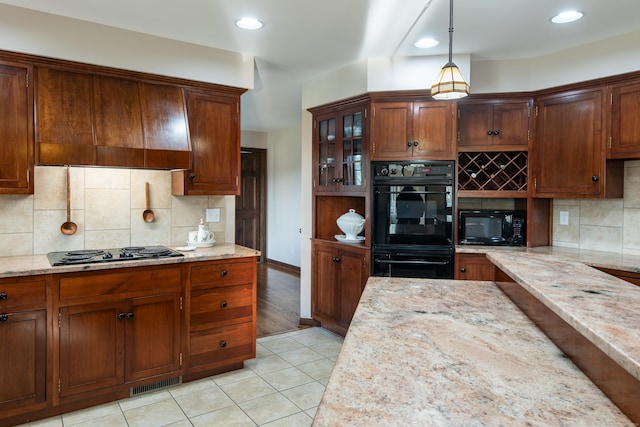 23 Hefflon Farm Rd, Old Lyme, CT 06371 - kitchen featuring black appliances, decorative backsplash, light stone counters, glass insert cabinets, and decorative light fixtures